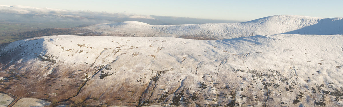 An aerial view from Bryn Teg of Cwm Cynwyn and Cefn Cyff, with the Black Mountains in the distance