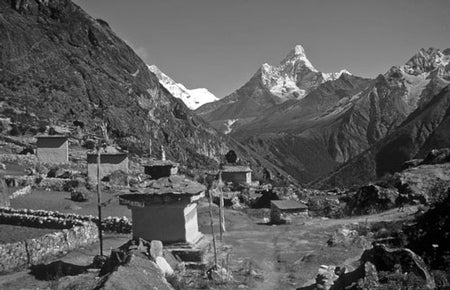 A Walk in the Clouds - Route Photos - On the edge of Khumjung, a solitary chorten, prayer flags and mani stones direct attention towards Ama Dablam