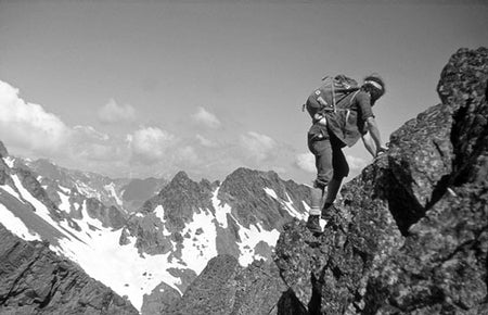 A Walk in the Clouds - Route Photos - Left foot in France, right foot in Spain – Keith Sweeting scrambles along a ridge leading to Pic de la Mine (Chapter 6)