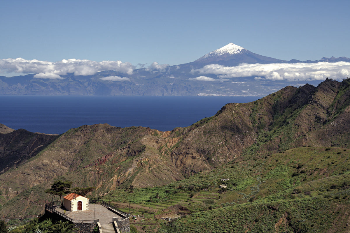 Walking on La Gomera and El Hierro - Route Photos - Looking down on the Ermita de San Juan, with El Teide on Tenerife far beyond (La Gomera, Walk 17)
