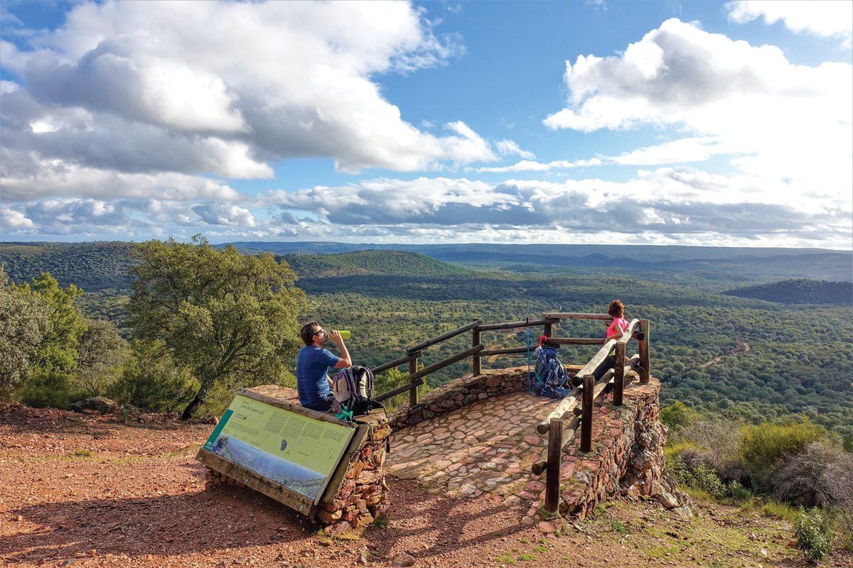 Walking La Via de la Plata and Camino Sanabres - Route Photos - Pilgrims take a breather atop the Cerro del Calvario with views of Finca El Berrocal (Stage 3)