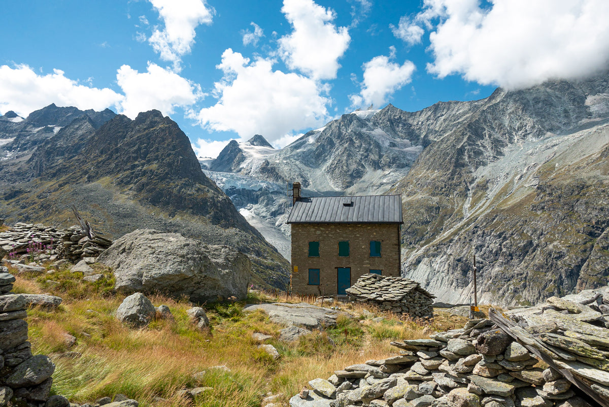 Walking in Arolla and Zinal - Route Photos - The Bricola building, Mont Miné to the left and the lower slopes of the Dent du Perroc to the right