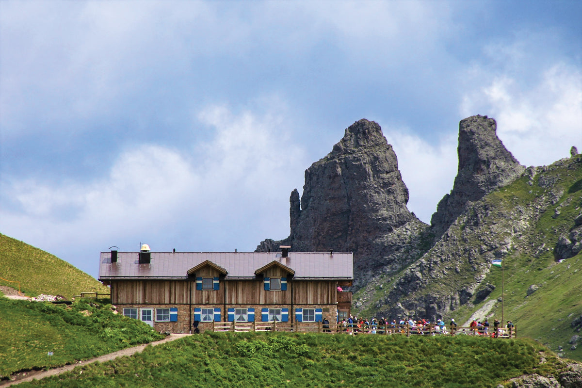 Alta Via 2 - Trekking in the Dolomites - Route Photos - Rifugio Viel del Pan, backed by curious lavic pinnacles (Stage 5)