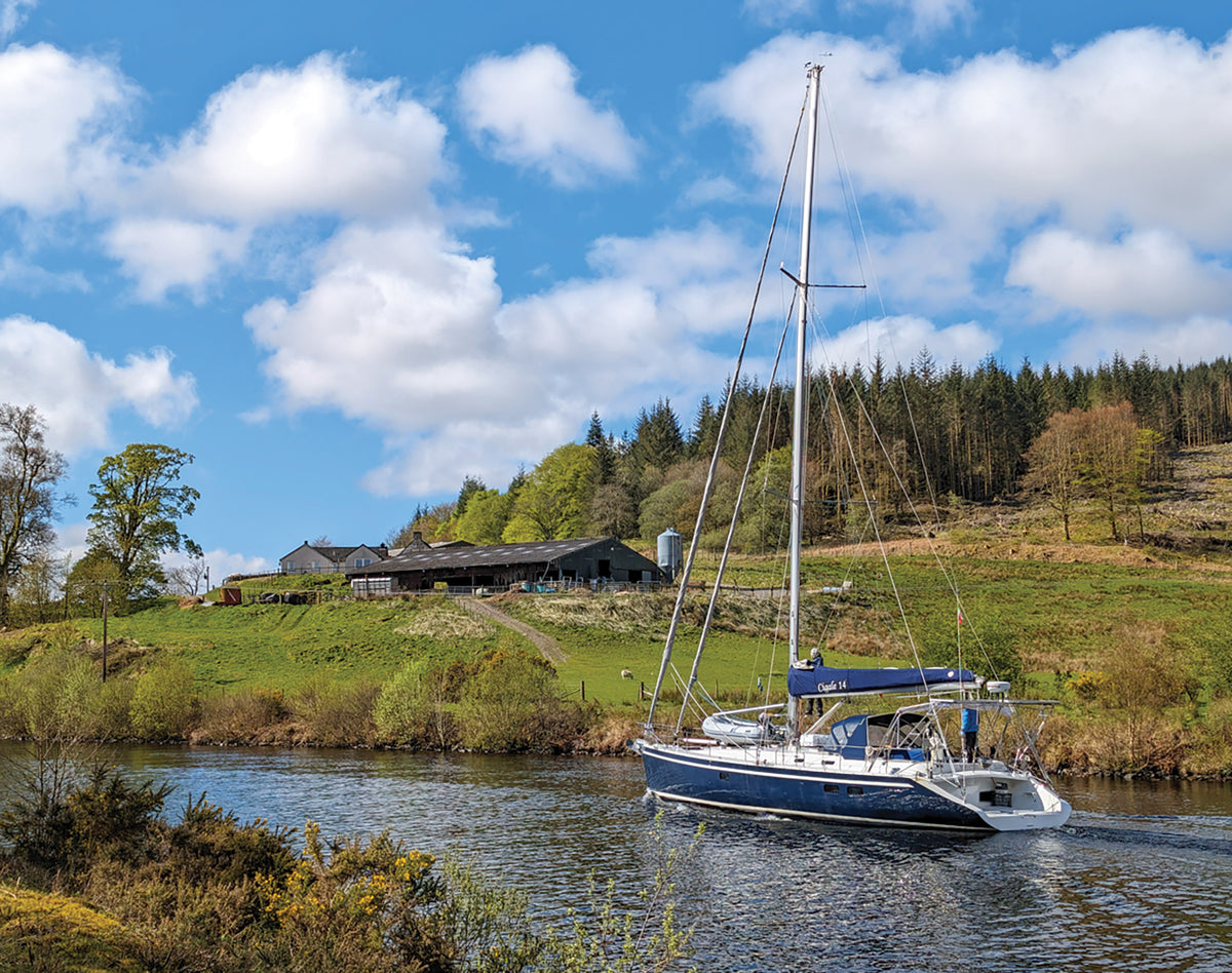 Walking the Great Glen Way - Route Photos - A boat navigates the Caledonian Canal above Banavie