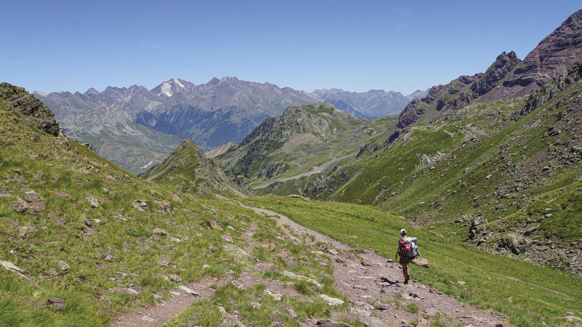 Trekking the GR11 Trail - Route Photos - On the way down to Formigal with the brown-white Picos del Infierno easily recognisible in the background (Stage 12)