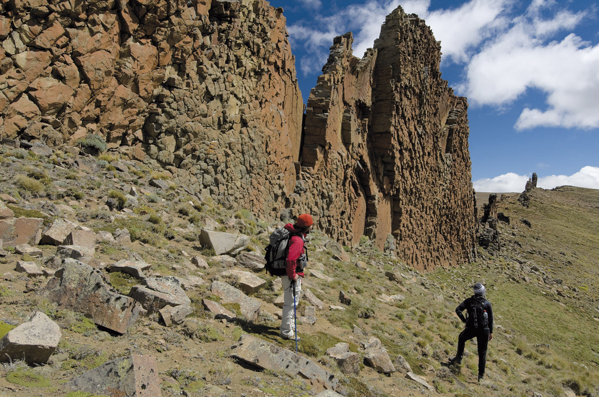 Trekking in Torres del Paine - Route Photos - Hikers below rock formations in Sierra Baguales (Other walks within the Torres del Paine national park)