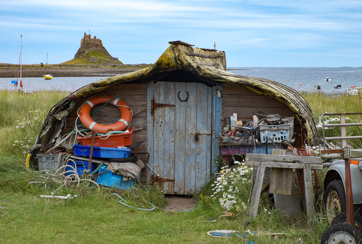 Walking in Northumberland - Route Photos - Upturned fishing boats now serve as sheds on Lindisfarne