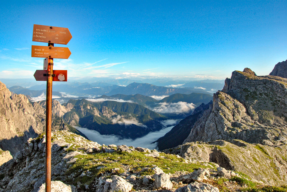 Walking the Julian Alps of Slovenia - Route Photos - Signposts on the grassy shoulder of Križ