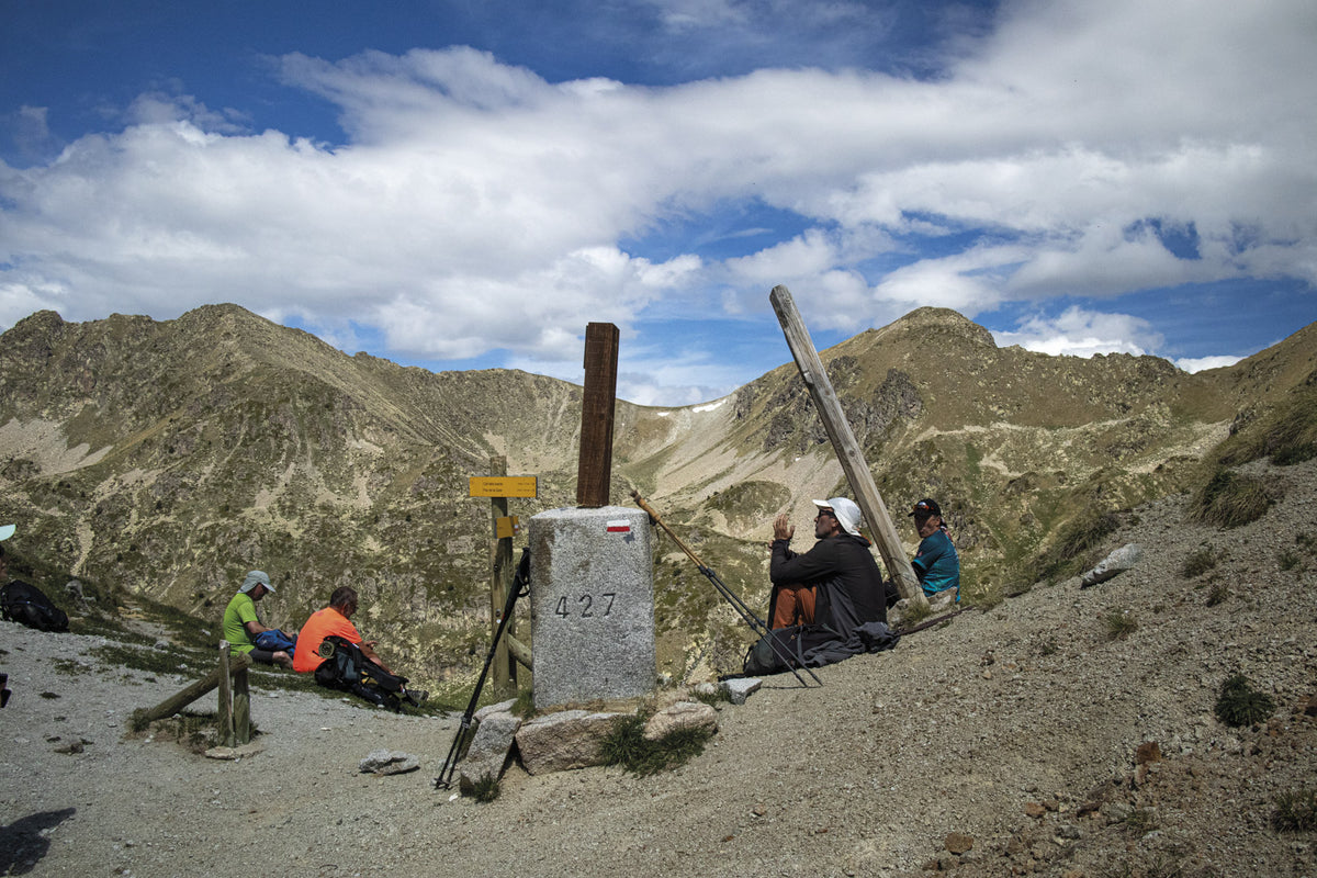 Trekking the Cami dels Bons Homes - Route Photos - Hikers resting at Portella Blanca before continuing on the GR107 into Catalonia