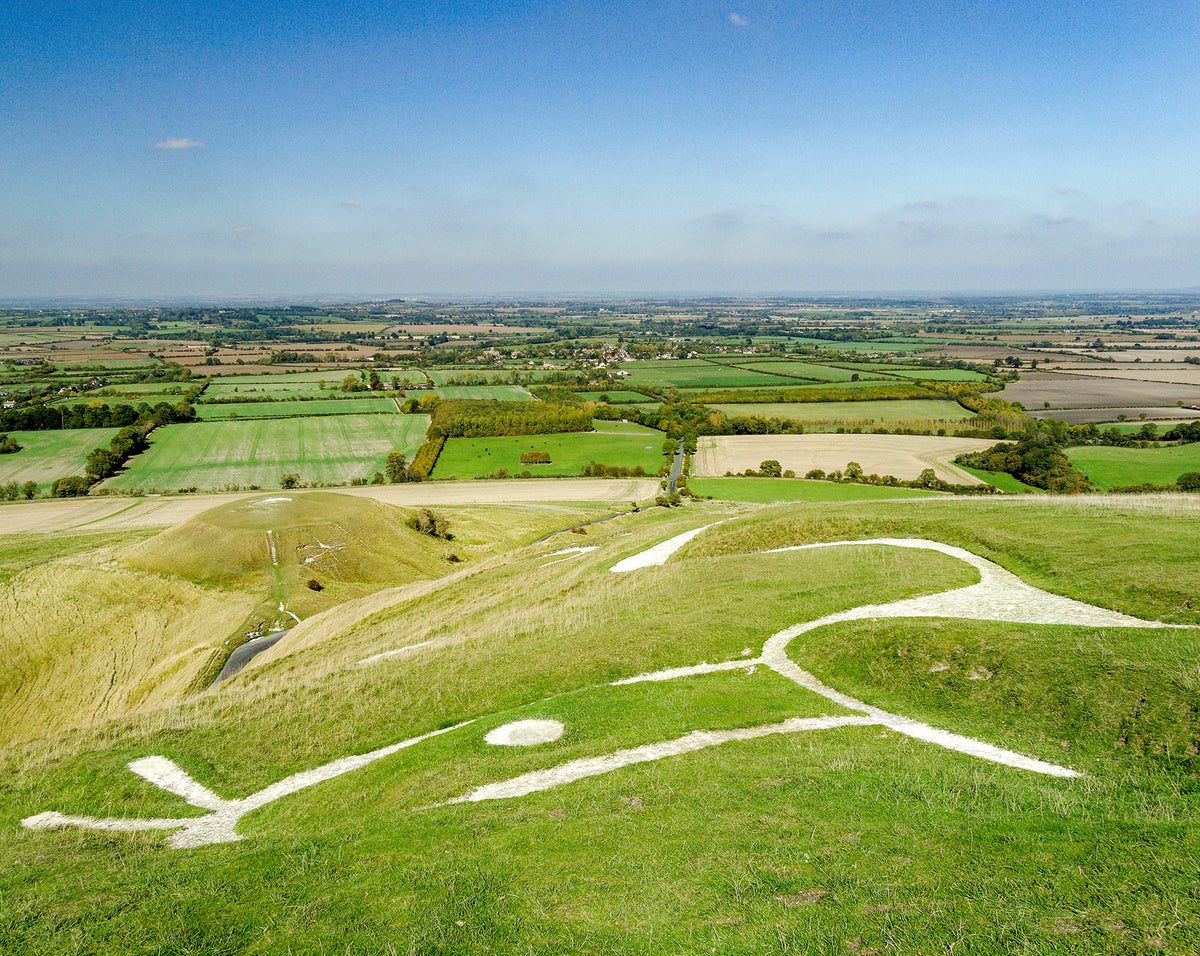 The Ridgeway National Trail - Route Photos - The stunning Uffington White Horse overlooking the flat-topped Dragon Hill and the Vale of White Horse