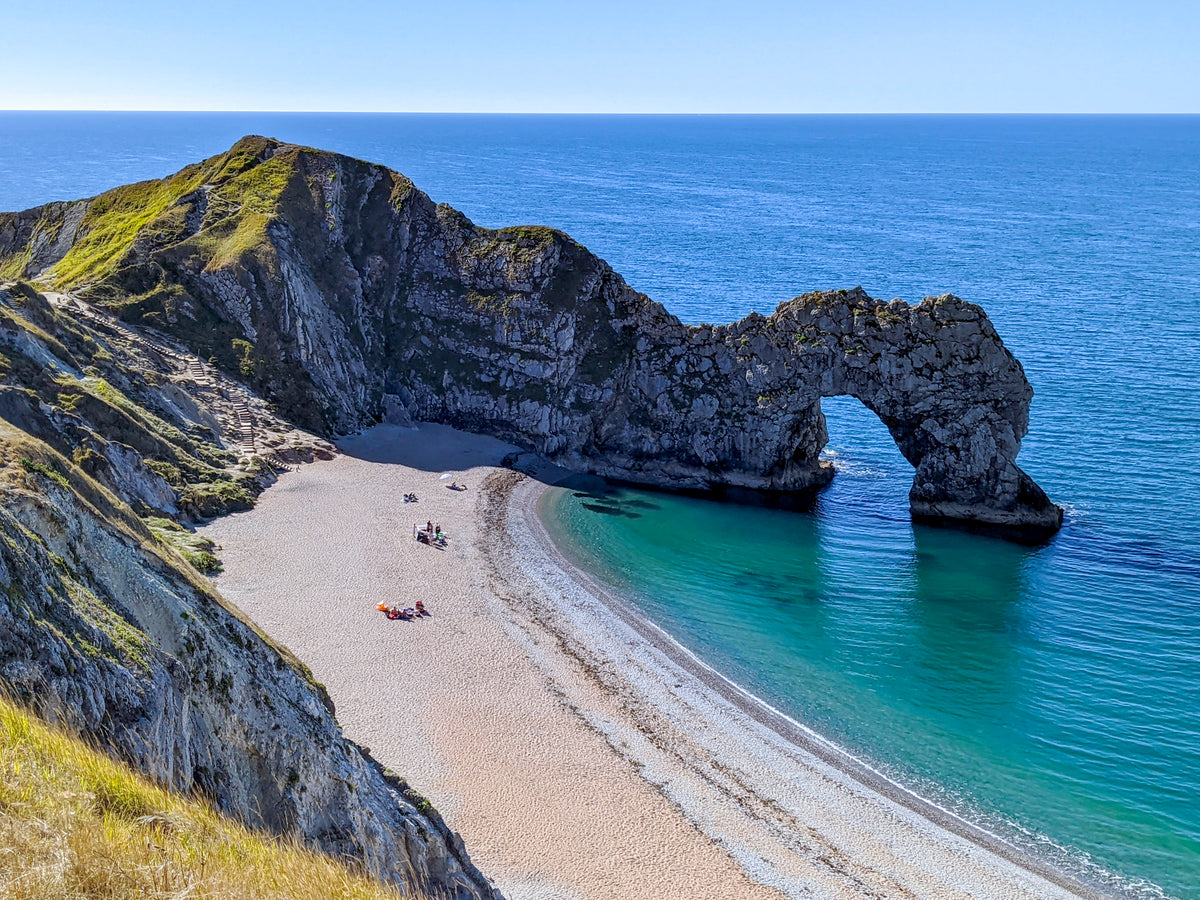 Walking the South West Coast Path - Route Photos - The iconic rock arch at Lulworth Cove, where the beach is only very rarely quiet